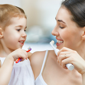 Mother & Daughter Brushing their teeth